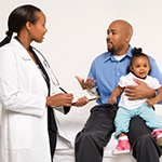 Doctor with parents and child